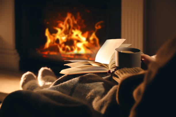 Person reading in dim warm light before bedtime